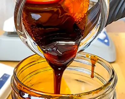 pouring hemp oil in a jar